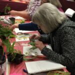 Master Gardener Volunteer studying a plant issue at a Plant Clinic