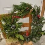 Holiday wreath resting on a chair