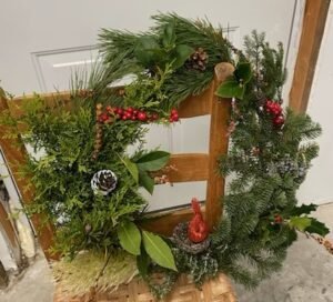 Holiday wreath resting on a chair