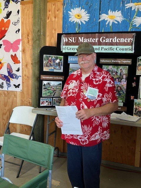 Master Gardener volunteer at the Pacific County Fair exhibit
